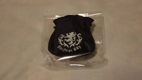 a small cloth bag with the logo in a plastic pouch